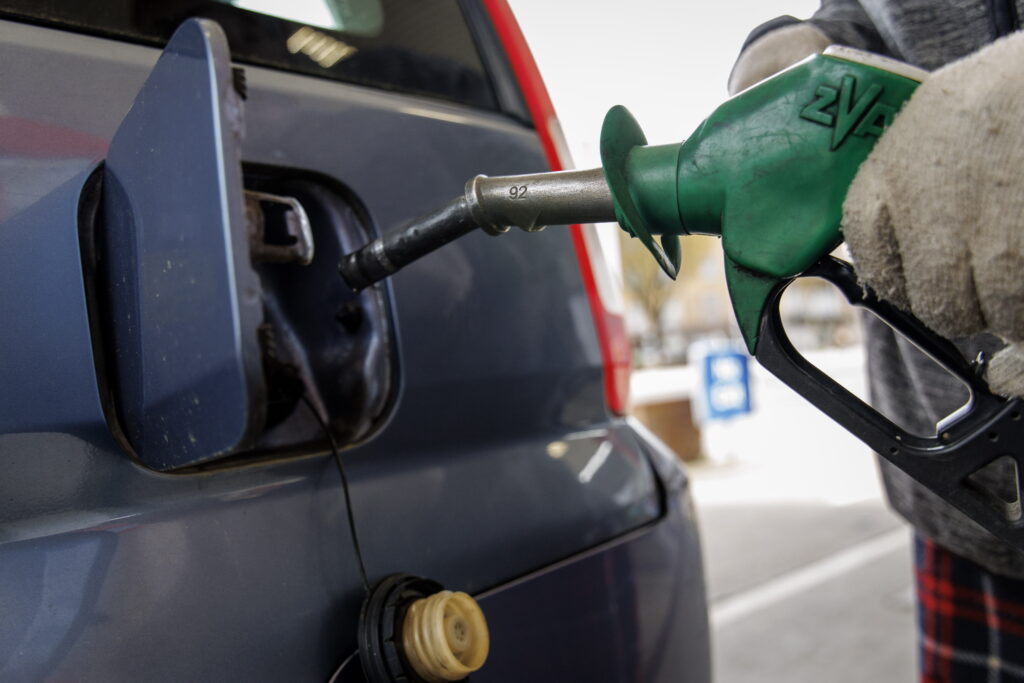 A person handles a fuel pump at a petrol station forecourt in London, Britain, 13 March 2026. Disruptions to oil shipping routes due to the closure of the Strait of Hormuz in the wake of US and Israeli military strikes on Iran and retaliatory attacks by Iran have led to a surge in fuel prices at UK petrol stations. Economists warn that this increase could raise inflation and reduce consumer spending.