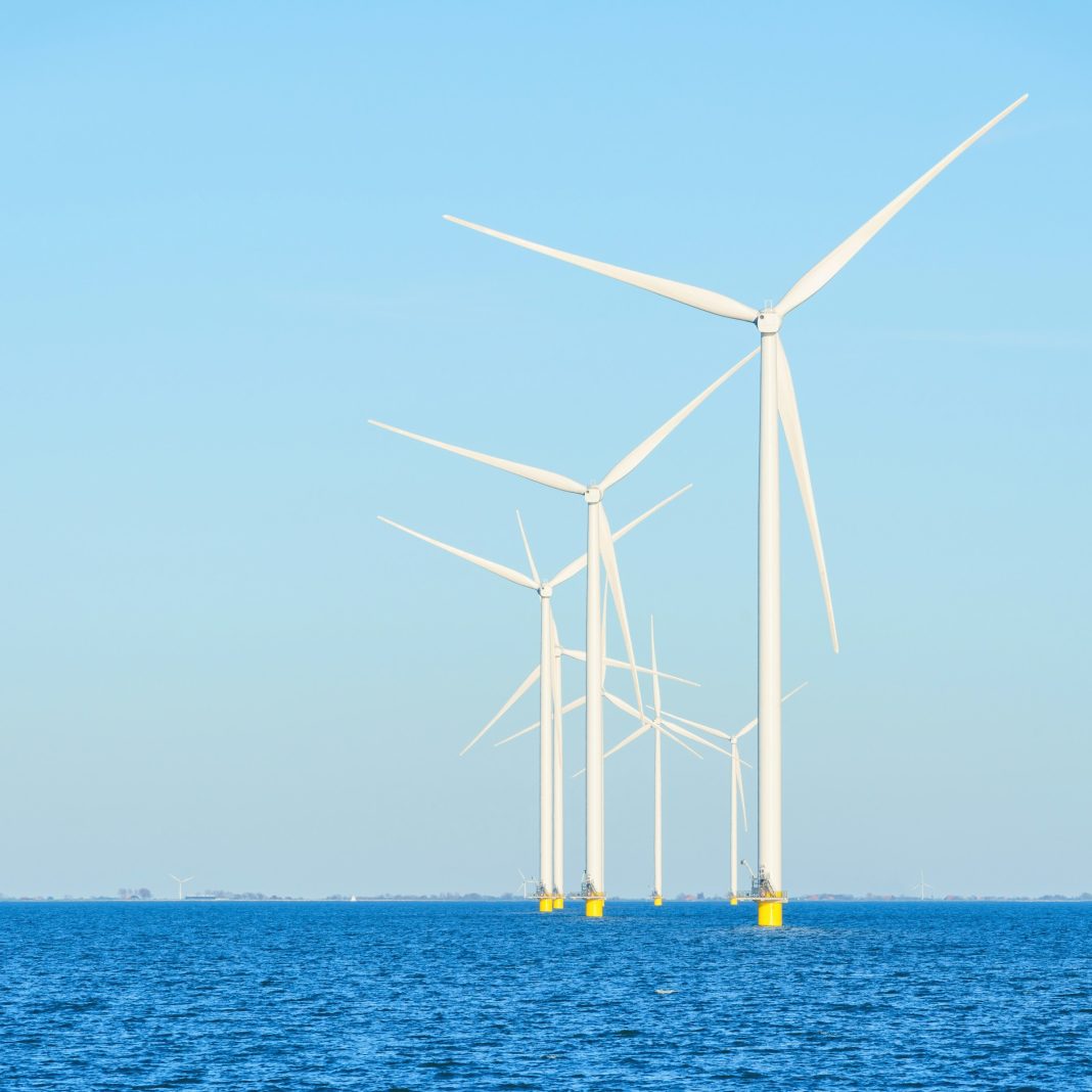 a group of wind turbines in the water